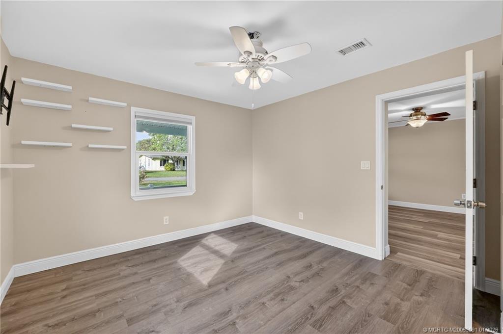607 Southeast Cortez Avenue Stuart, FL 34994 - Photo 20 of 29 wooden floor in an empty room with a window