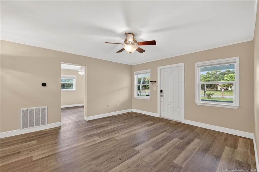 607 Southeast Cortez Avenue Stuart, FL 34994 - Photo 6 of 29 wooden floor in an empty room with a window