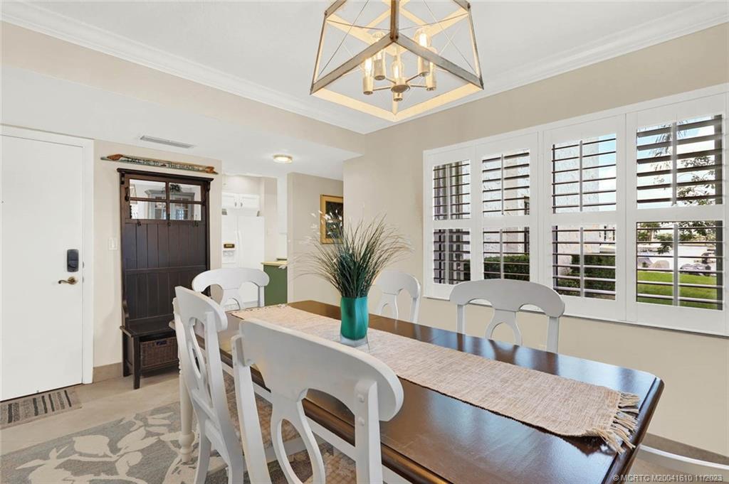 1950 Southwest Palm City Road, Unit 4107 Stuart, FL 34994 - Photo 11 of 65 a view of a dining room with furniture window and wooden floor
