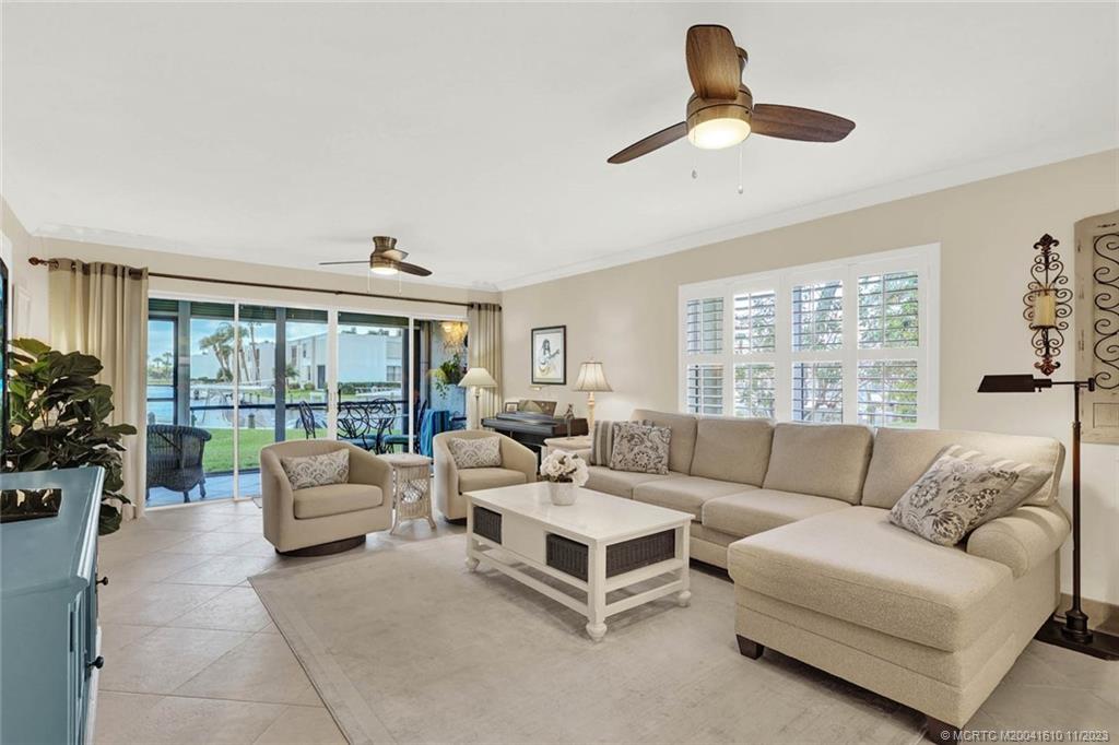 1950 Southwest Palm City Road, Unit 4107 Stuart, FL 34994 - Photo 16 of 65 a living room with furniture and a large window
