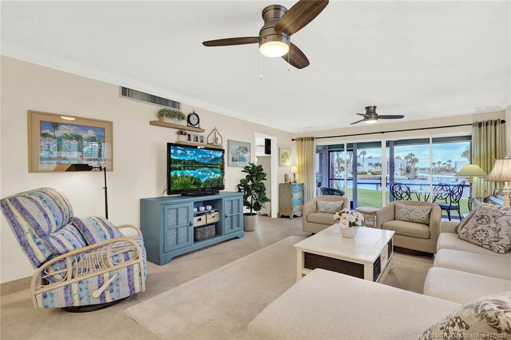 1950 Southwest Palm City Road, Unit 4107 Stuart, FL 34994 - Photo 17 of 65 a living room with furniture a rug and a flat screen tv
