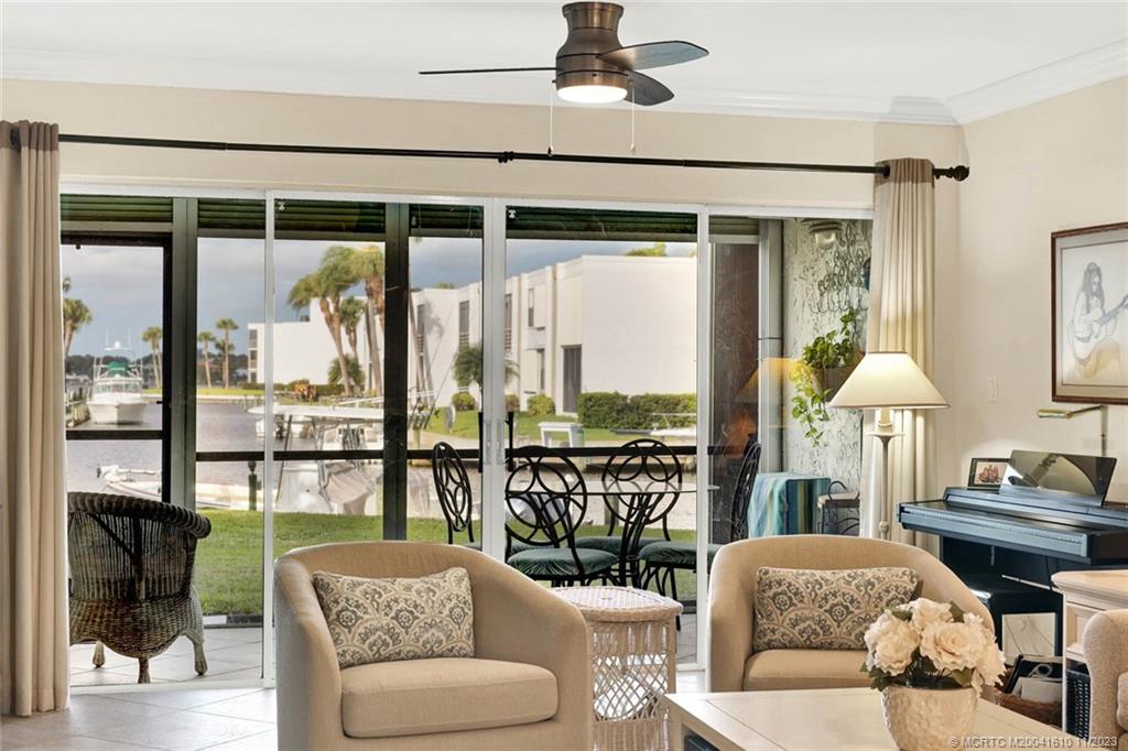 1950 Southwest Palm City Road, Unit 4107 Stuart, FL 34994 - Photo 18 of 65 a living room with furniture and a large window