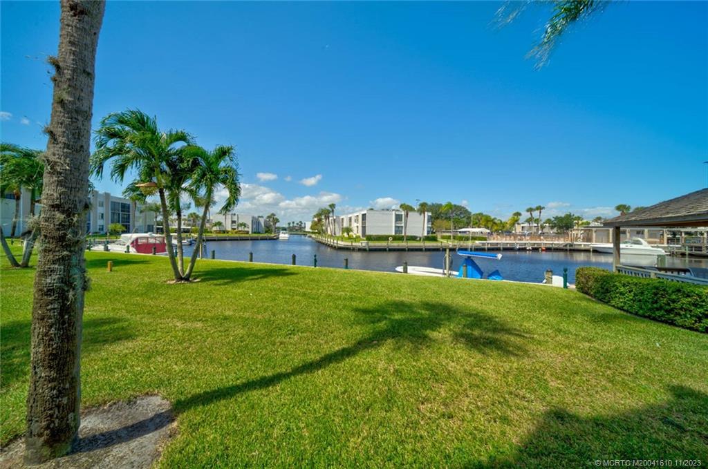 1950 Southwest Palm City Road, Unit 4107 Stuart, FL 34994 - Photo 22 of 65 a view of yard with swimming pool and outdoor seating