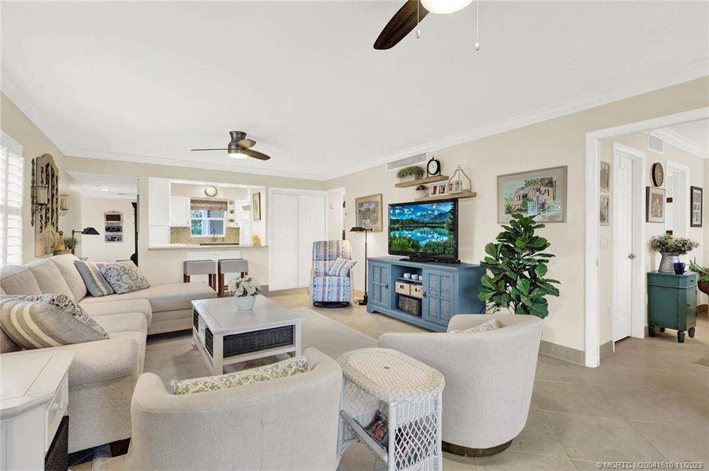 1950 Southwest Palm City Road, Unit 4107 Stuart, FL 34994 - Photo 24 of 65 a living room with furniture and a flat screen tv