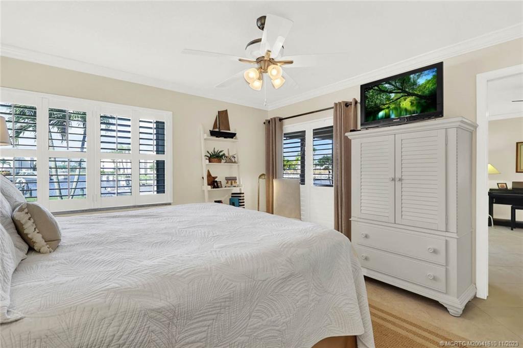 1950 Southwest Palm City Road, Unit 4107 Stuart, FL 34994 - Photo 27 of 65 a bedroom with a bed mirror and window