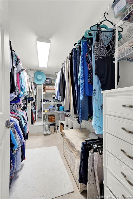1950 Southwest Palm City Road, Unit 4107 Stuart, FL 34994 - Photo 30 of 65 a view of walk in closet with clothes and shoes