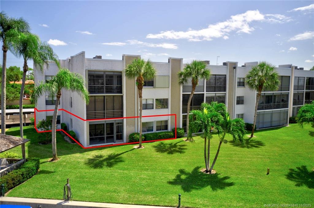 1950 Southwest Palm City Road, Unit 4107 Stuart, FL 34994 - Photo 3 of 65 a view of a garden with a house in the background