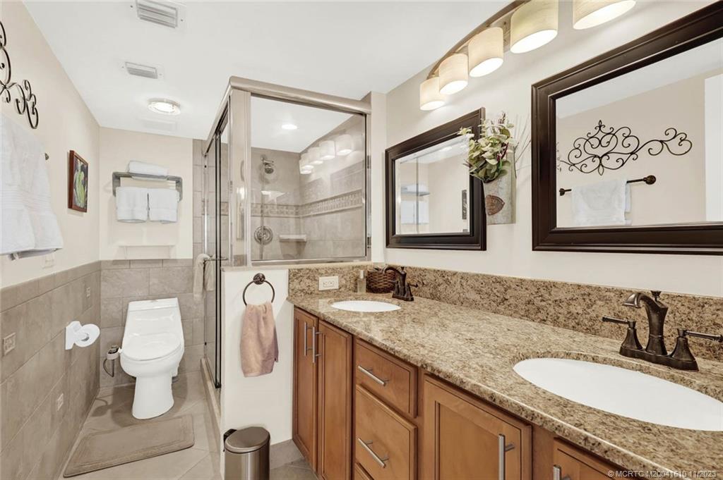 1950 Southwest Palm City Road, Unit 4107 Stuart, FL 34994 - Photo 31 of 65 a bathroom with a granite countertop sink and a mirror