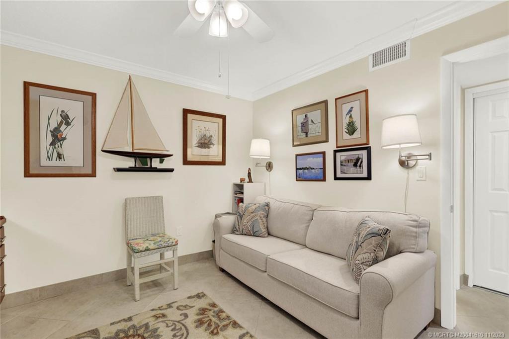 1950 Southwest Palm City Road, Unit 4107 Stuart, FL 34994 - Photo 32 of 65 a living room with furniture and a large window