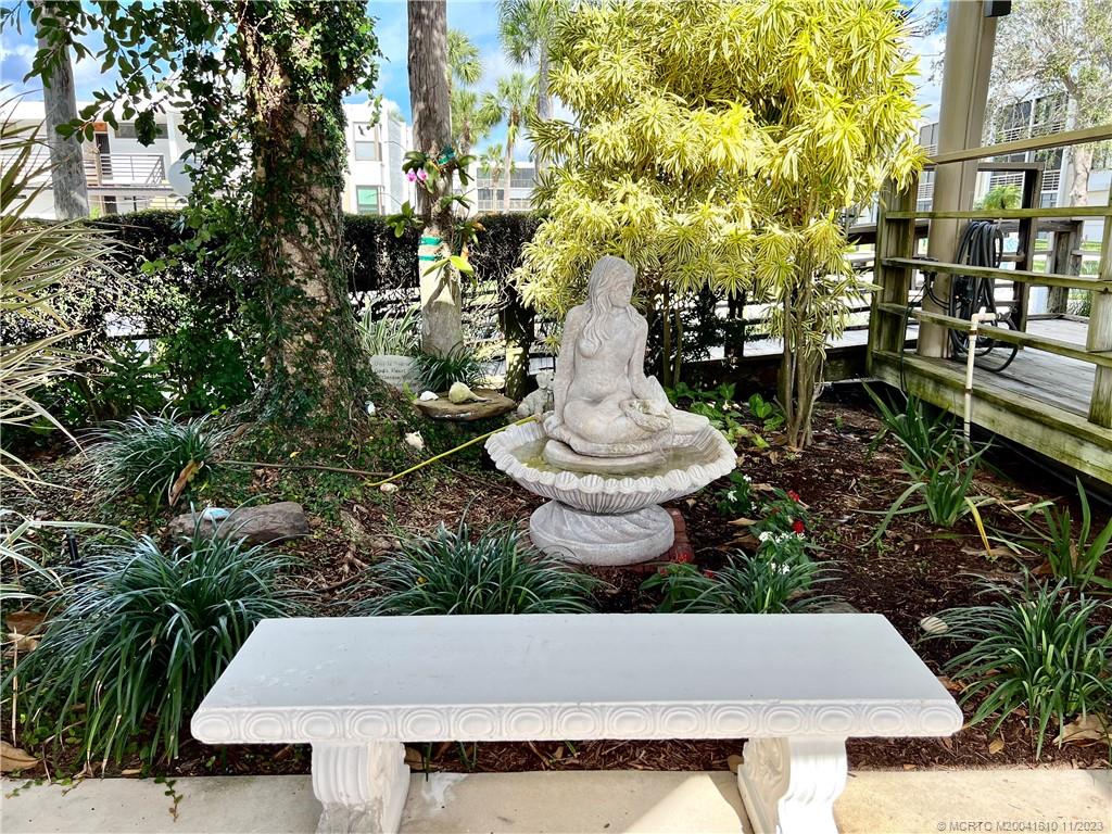 1950 Southwest Palm City Road, Unit 4107 Stuart, FL 34994 - Photo 52 of 65 a wooden bench sitting in backside of a house