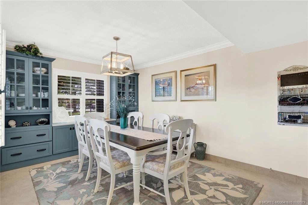 1950 Southwest Palm City Road, Unit 4107 Stuart, FL 34994 - Photo 10 of 65 a dining room with furniture a chandelier and window