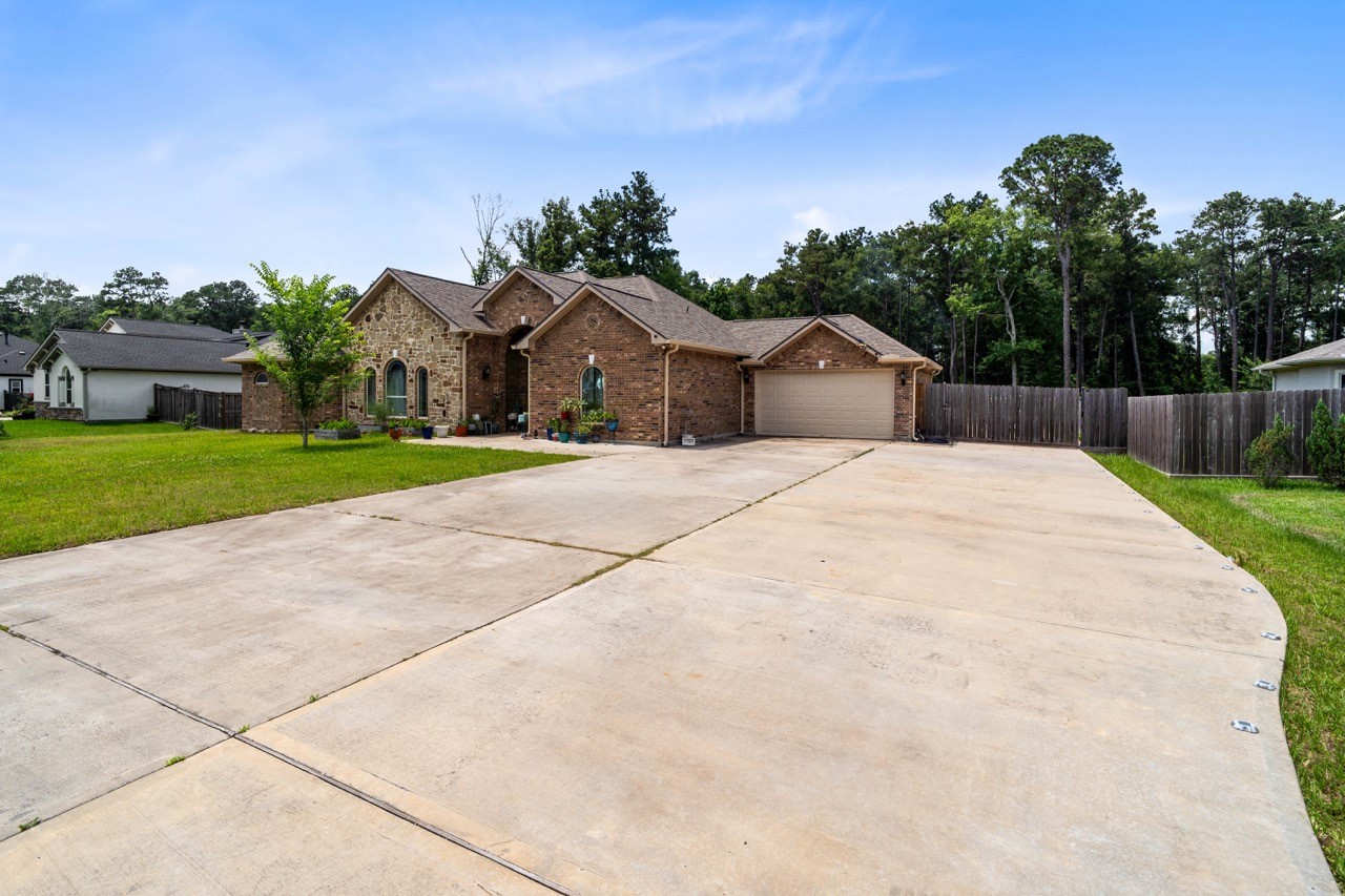 27585 Rio Blanco Drive Splendora, TX 77372 - Photo 3 of 39 Extra wide and long driveway. No parking problem here. Plenty of room for family and friends. Driveway continues through the double gate to the backyard.