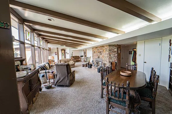 a living room with furniture and a floor to ceiling window