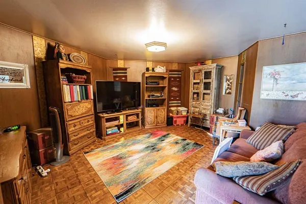 a view of a hallway with living area and dining room view