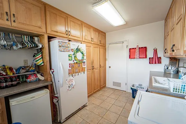a utility room with sink dryer and washer