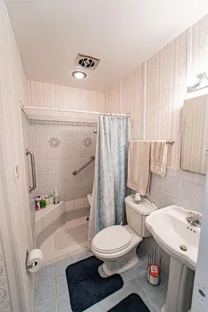 a view of bathroom with a sink and mirror