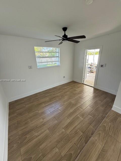 17860 Southwest 112th Court Miami, FL 33157 - Photo 15 of 17 an empty room with wooden floor a ceiling fan and windows