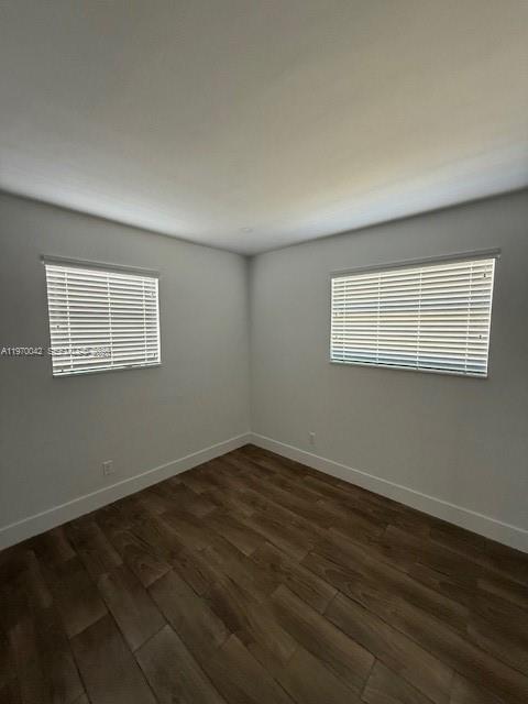 17860 Southwest 112th Court Miami, FL 33157 - Photo 5 of 17 a view of an empty room with wooden floor and a window