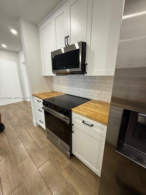 17860 Southwest 112th Court Miami, FL 33157 - Photo 8 of 17 a kitchen with granite countertop a stove and a microwave
