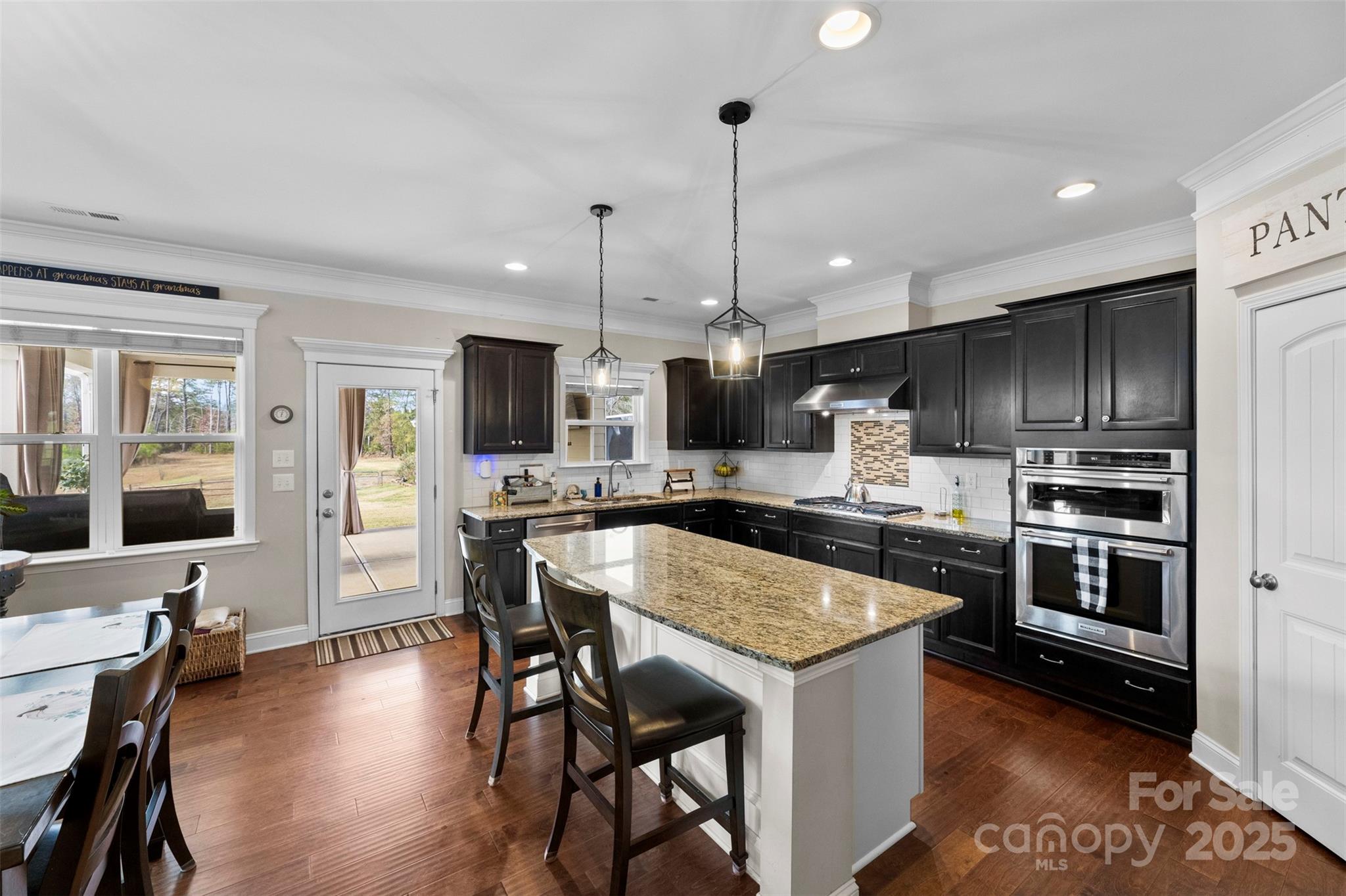 164 Reese Wilson Road Belmont, NC 28012 - Photo 7 of 27 a kitchen with stainless steel appliances granite countertop a stove refrigerator and chairs
