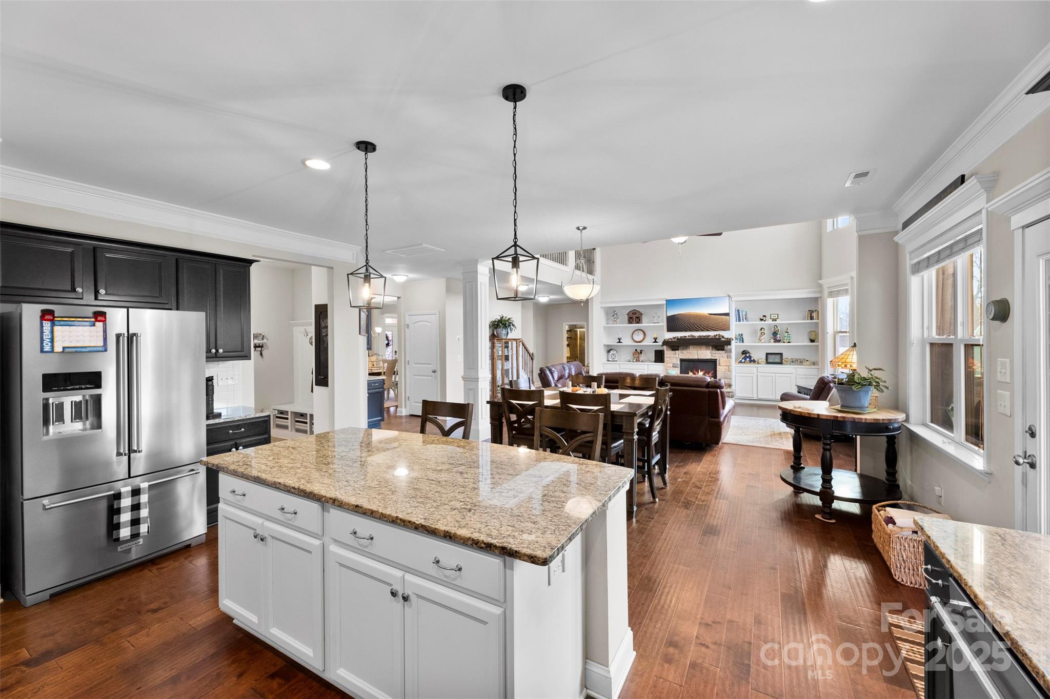 164 Reese Wilson Road Belmont, NC 28012 - Photo 8 of 27 a kitchen with stainless steel appliances kitchen island granite countertop a refrigerator a sink dishwasher a oven and a dining table with wooden floor