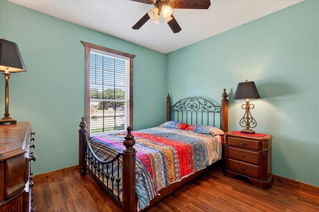 11591 Farm To Market 59 Athens, TX 75751 - Photo 17 of 40 4th bedroom on Level 1 with Wood-finish flooring, ceiling fan and closet. Window view.