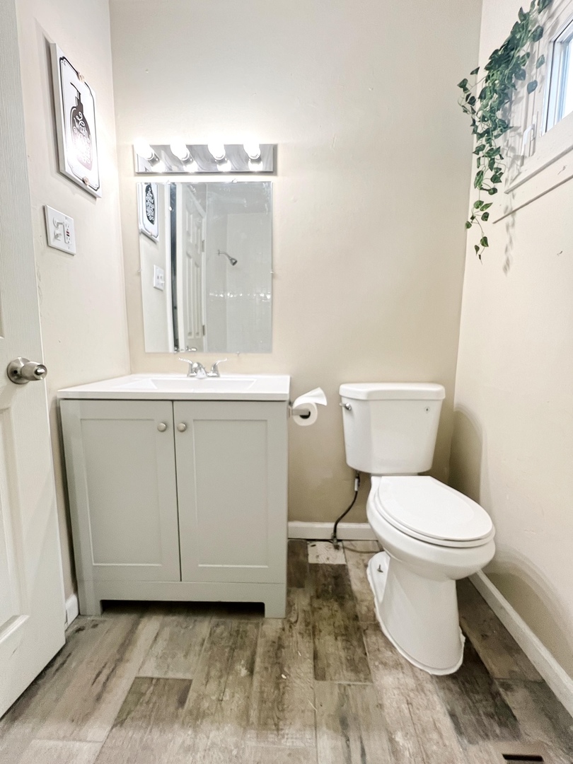 4764 South Shields Avenue Chicago, IL 60609 - Photo 2 of 10 a white toilet sitting next to a bathroom sink