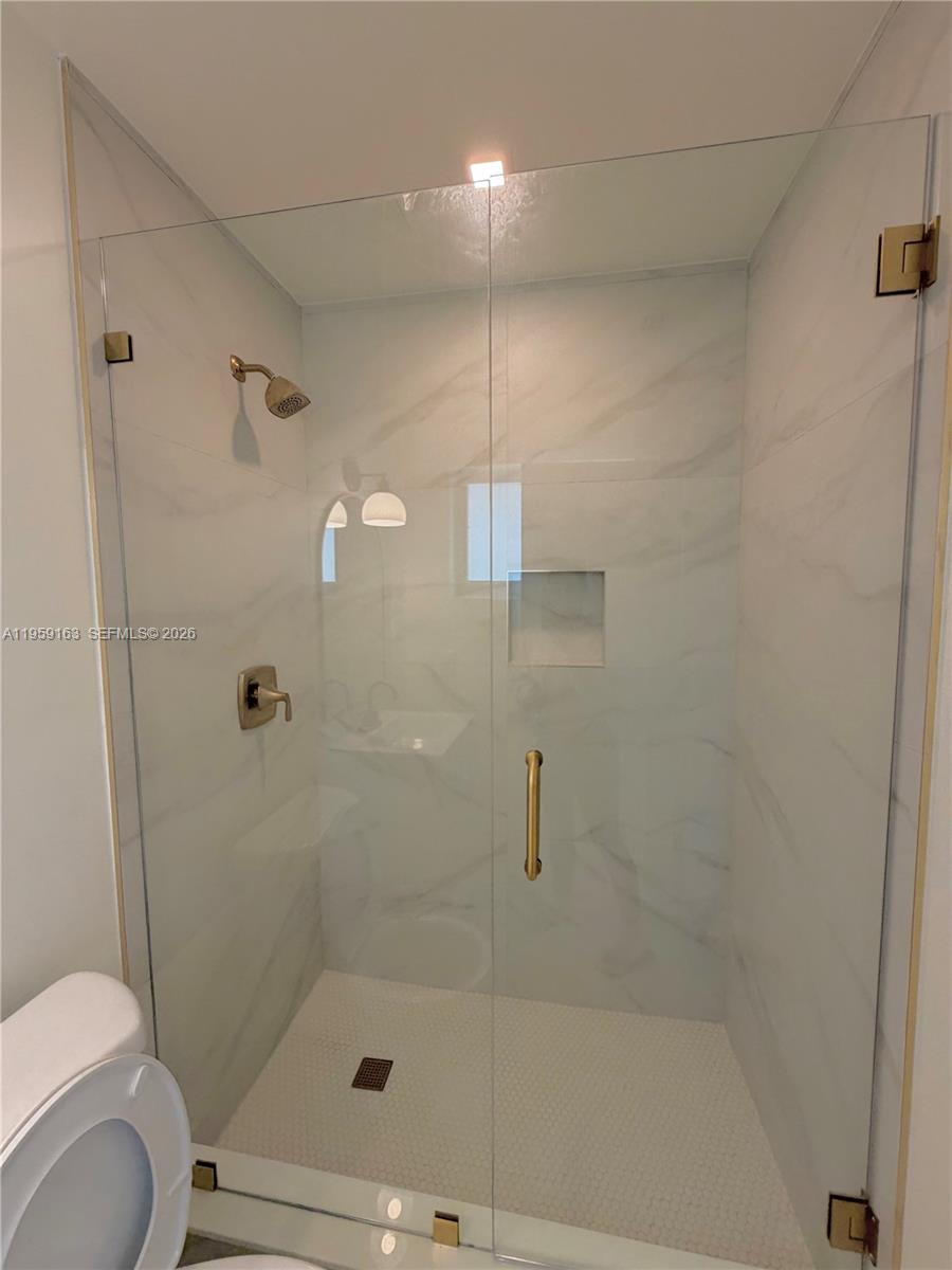19221 Southwest 92nd Road Cutler Bay, FL 33157 - Photo 28 of 30 a bathroom with a shower and toilet
