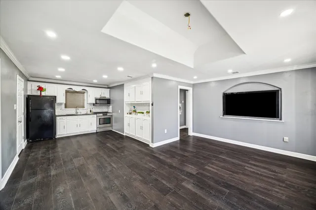 a view of kitchen with wooden floor and electronic appliances