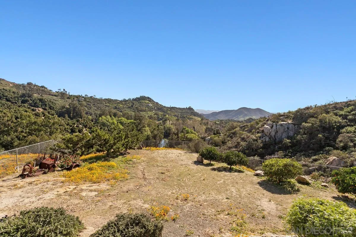 6167 Rainbow Heights Road Fallbrook, CA 92028 - Photo 9 of 44 a view of a dry yard with mountains in the background