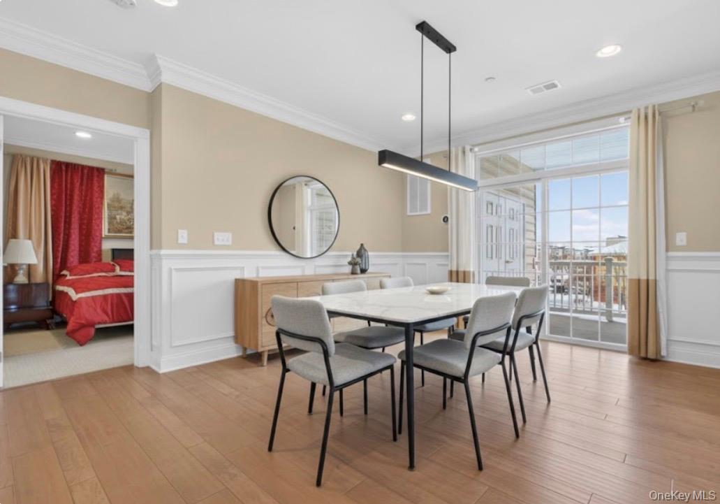 734 Regency Drive Fishkill, NY 12524 - Photo 11 of 50 a dining room with furniture a chandelier and wooden floor