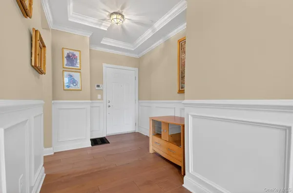 a view of a hallway with furniture and a window