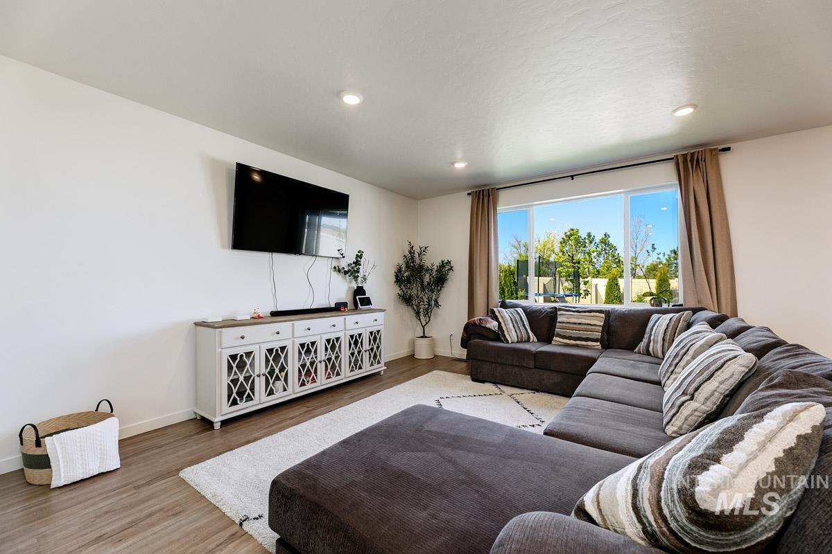 4469 South Colditz Way Meridian, ID 83642 - Photo 11 of 30 Spacious room featuring wood-finish flooring, recessed lighting, and a large picture window with outdoor views