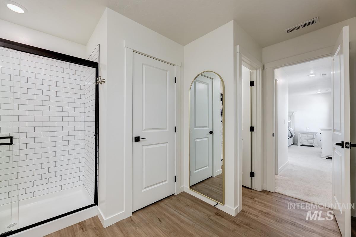 4469 South Colditz Way Meridian, ID 83642 - Photo 19 of 30 Walk-in shower with subway tile surround and black-framed glass enclosure