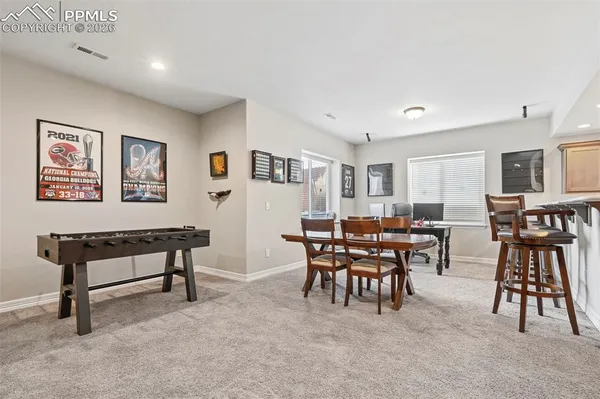 a view of a livingroom with furniture and a dining table