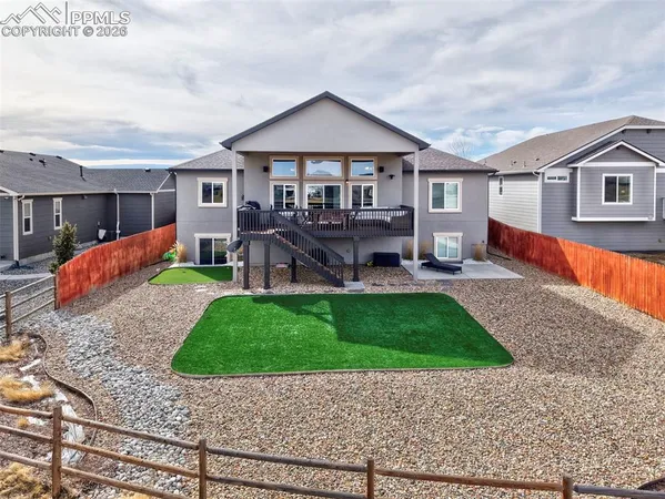 a front view of a house with a yard fire pit table and chairs