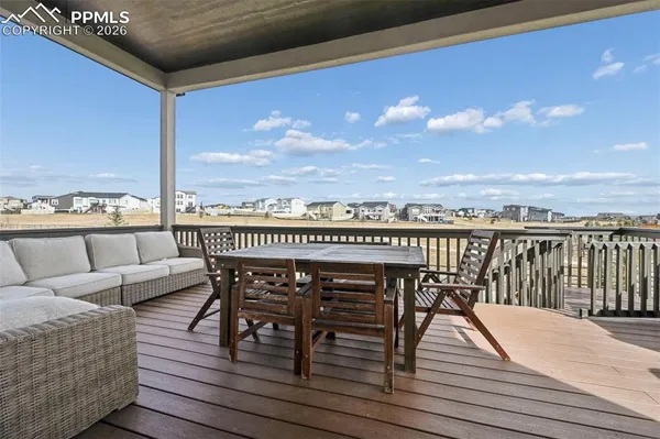 a view of a balcony with furniture and wooden floor