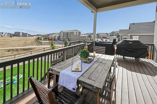 a view of a balcony with wooden benches