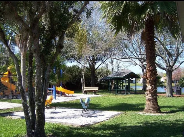 a view of a room with furniture and a ceiling fan