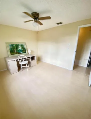 a bedroom with a bed and a night stand