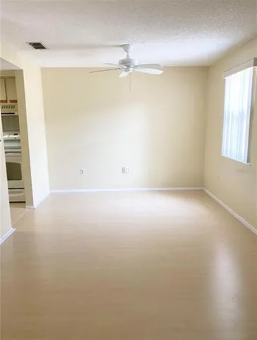an empty room with an entryway and closet area