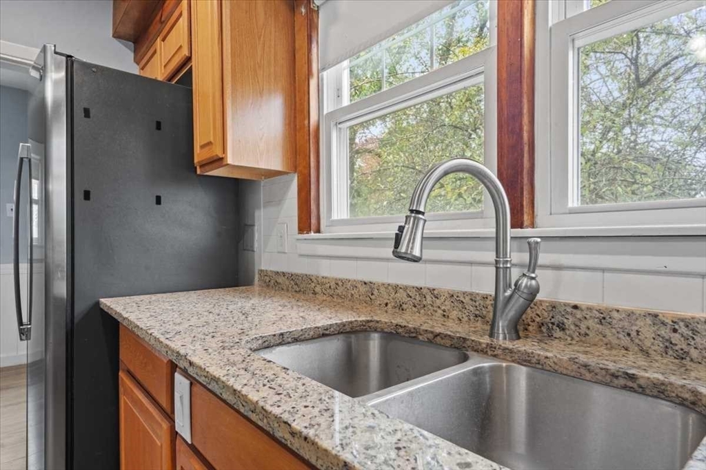 131 South Main Street Clinton, MA 01510 - Photo 16 of 36 a kitchen with granite countertop a sink and a window