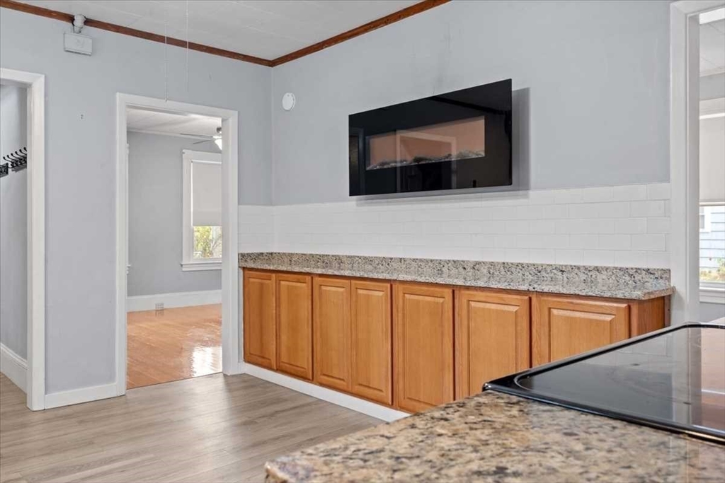131 South Main Street Clinton, MA 01510 - Photo 19 of 36 a hallway with sliding door and wooden floor
