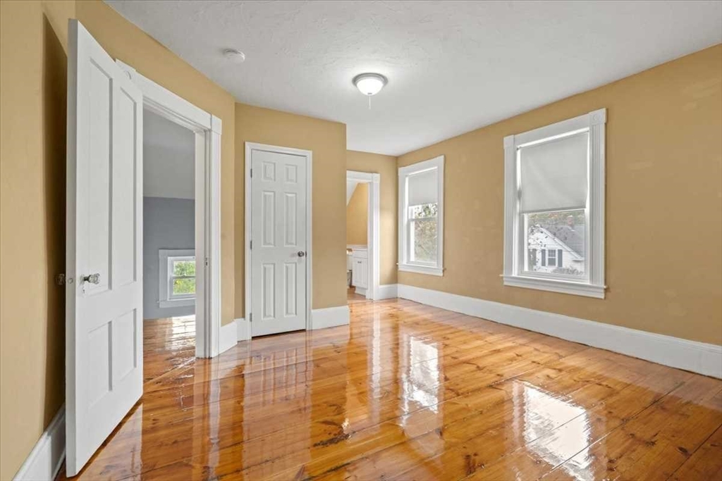 131 South Main Street Clinton, MA 01510 - Photo 25 of 36 a view of an empty room with window and wooden floor