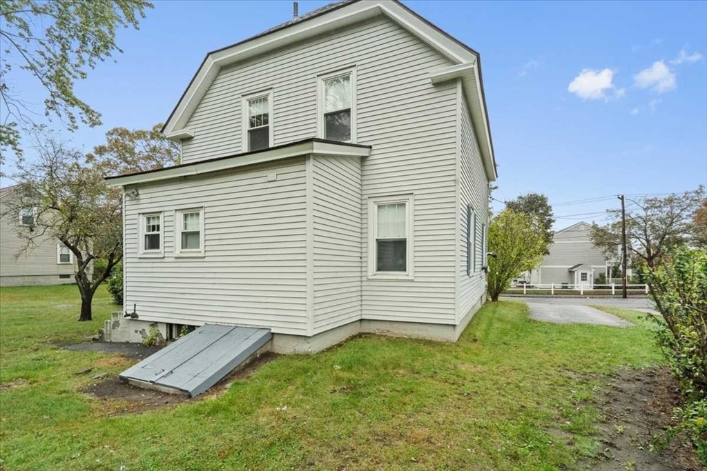 131 South Main Street Clinton, MA 01510 - Photo 31 of 36 a view of a house with a yard and a garden