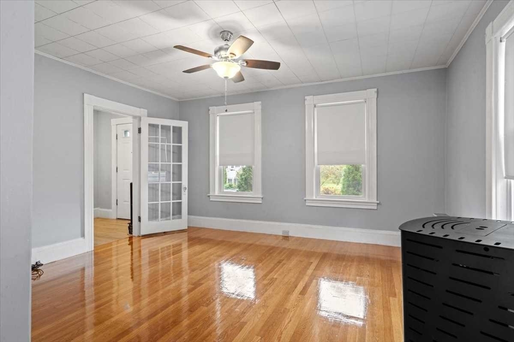 131 South Main Street Clinton, MA 01510 - Photo 7 of 36 a view of an empty room with a window and wooden floor