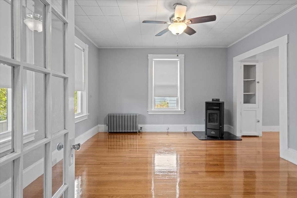 131 South Main Street Clinton, MA 01510 - Photo 8 of 36 a bedroom with a bed and a chandelier