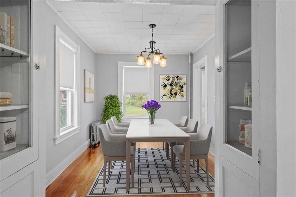 131 South Main Street Clinton, MA 01510 - Photo 10 of 36 a dining room with furniture a chandelier and wooden floor