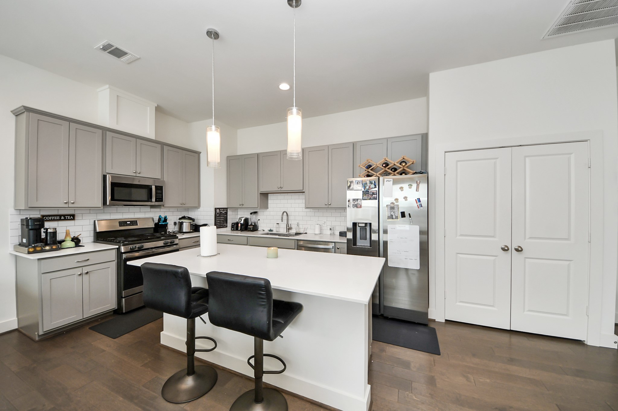 3622 Griggs Road Houston, TX 77021 - Photo 2 of 30 a kitchen with kitchen island white cabinets and stainless steel appliances