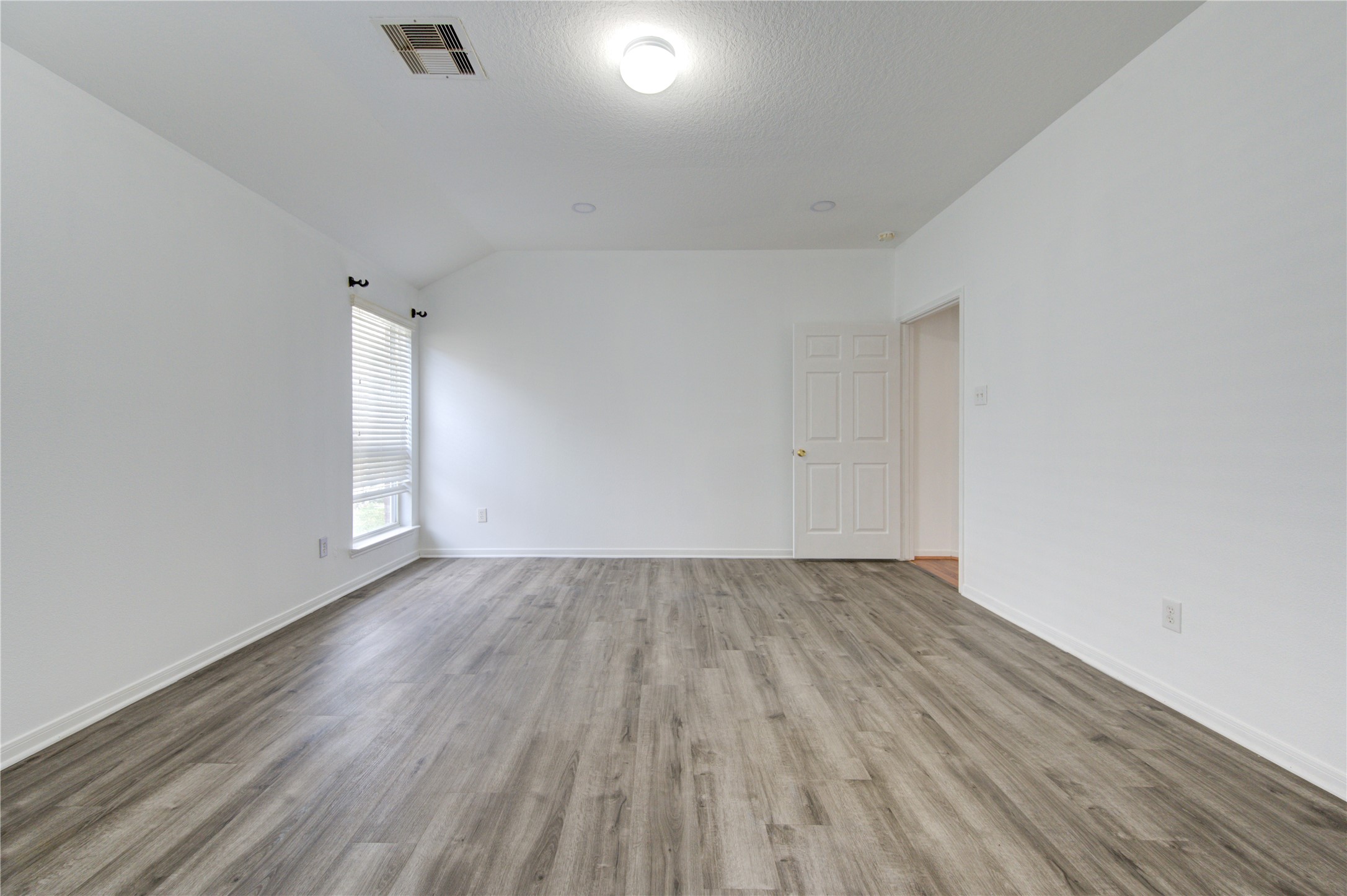 14315 Acorn Ridge Way Cypress, TX 77429 - Photo 13 of 22 an empty room with wooden floor and windows